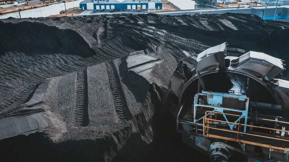 Machine digging coal in daylight