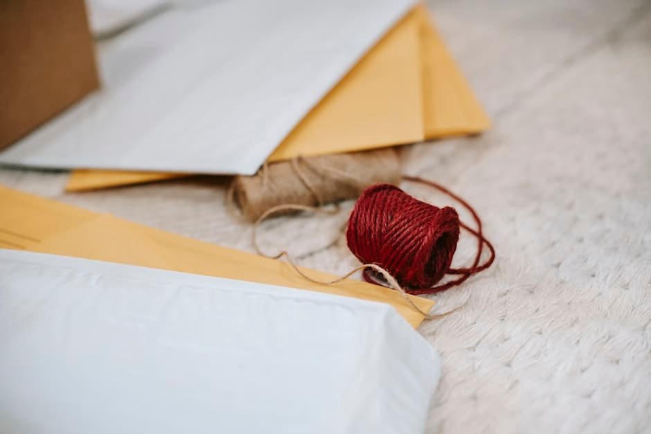 Woolen red and beige twine thread bobbins among envelopes